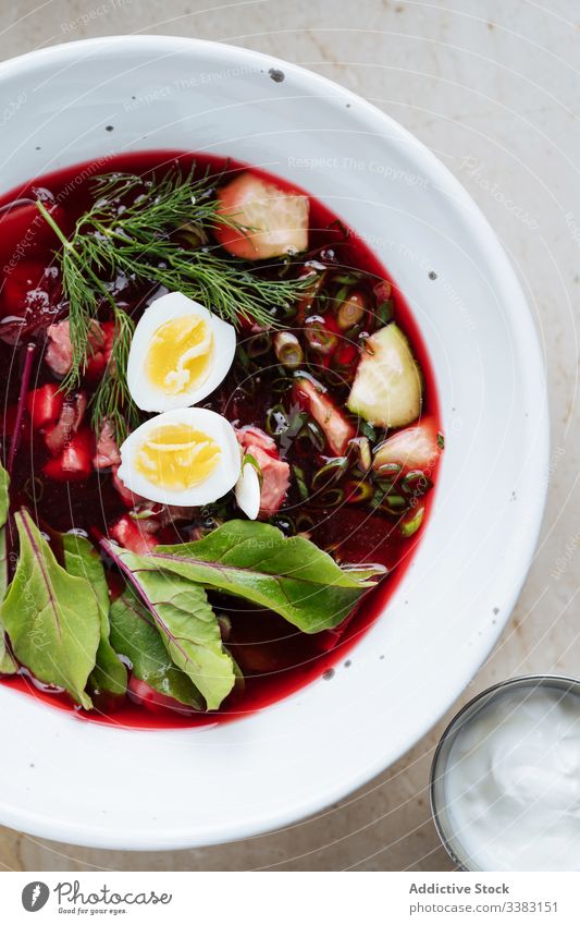 Colorful beetroot soup with eggs and herbs in plate green delicious food tasty fresh dish cuisine meal vegetable bowl healthy gourmet ingredient nutrition