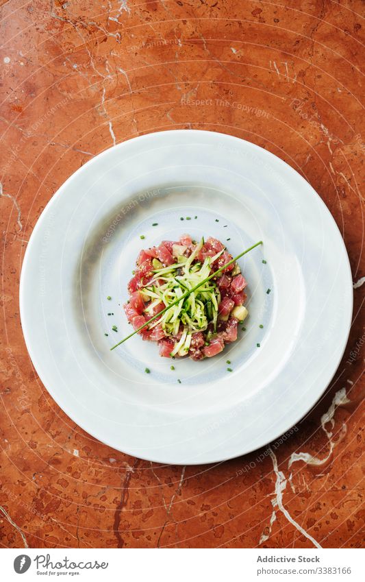 Luxury tuna tartar with red fish in restaurant herb vegetable haute cuisine seafood cucumber organic tradition plate delicious healthy meal dish portion tasty