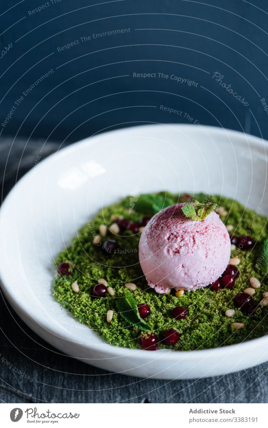 Stylish dessert with ice cream in restaurant nuts mousse haute cuisine bowl scoop green delicious food yummy tasty dish ball sorbet plate flavor berry organic