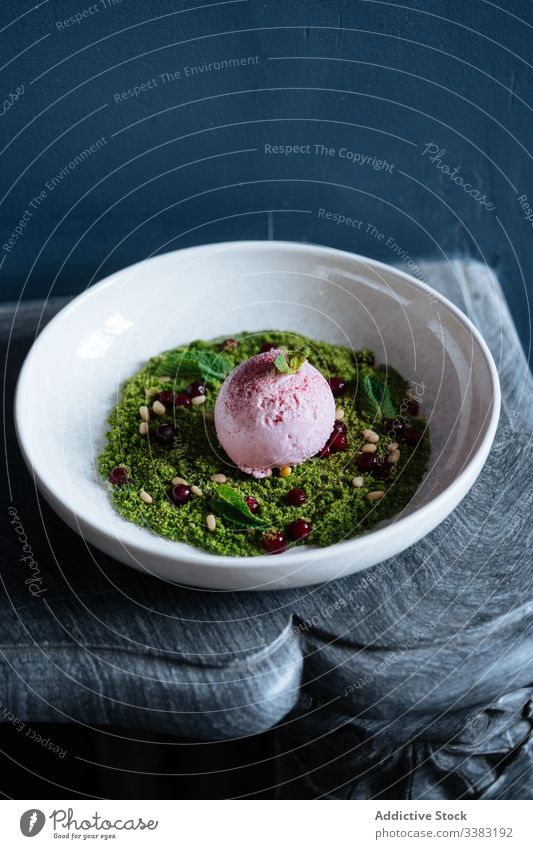 Stylish dessert with ice cream in restaurant nuts mousse haute cuisine bowl scoop green delicious food yummy tasty dish ball sorbet plate flavor berry organic