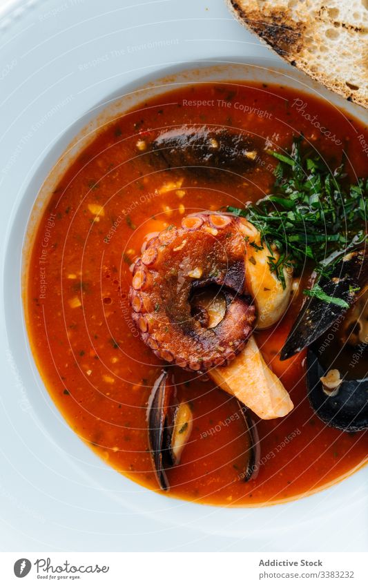 Delicious tom yum with octopus in restaurant soup seafood mussels asian food haute cuisine herb greenery delicious meal tasty dish lunch gourmet portion