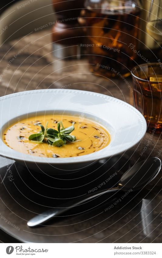 Cream soup served with drinks on table in restaurant cream blended dish meal dinner food lunch delicious cuisine tasty gourmet tradition portion fresh vegetable
