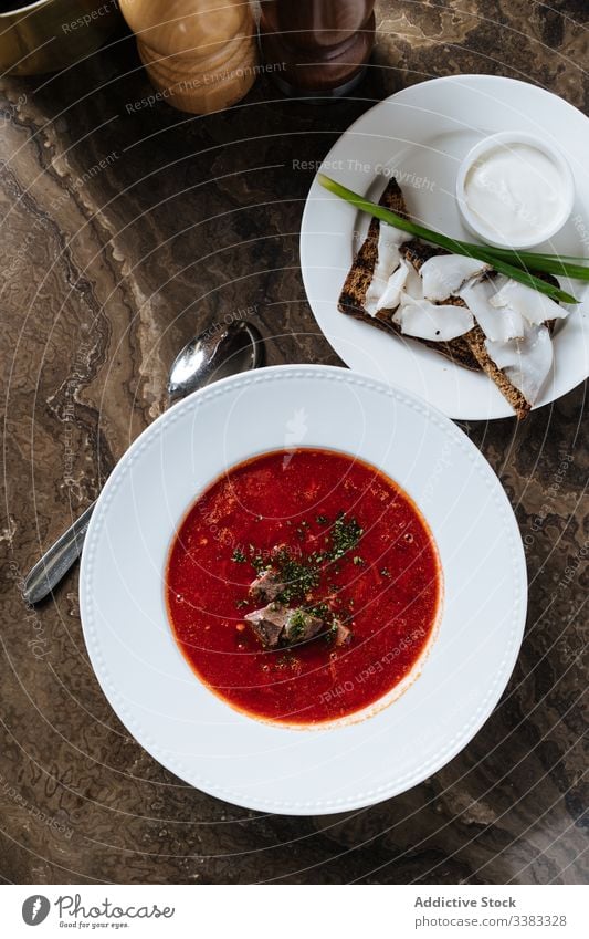 Served borsch with bread and bacon on table in restaurant soup dish delicious meal food cuisine tasty gourmet onion fresh portion bowl organic ingredient herb