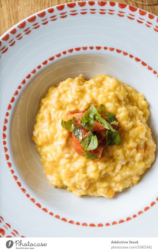 Risotto with vegetables garnished with tomatoes on table pumpkin risotto green food delicious tasty meal dish gourmet fresh culinary breakfast portion yellow