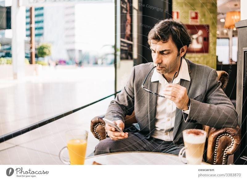 Worried businessman having a breakfast on a bar adult cafe cellphone city coffee computer copy space depressed depression discomfort executive exhausted fatigue