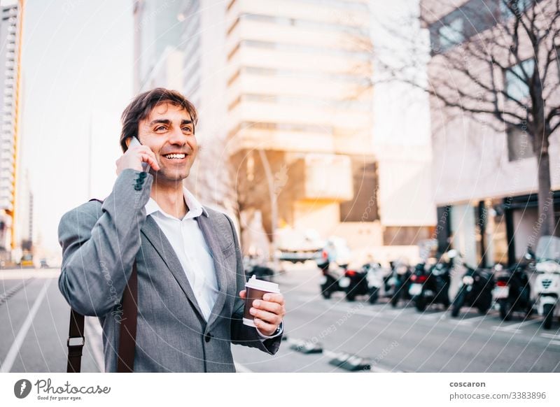 Smiling businessman talking by phone adult attractive barcelona blue building call calling cell cellphone cheerful city closeup communication confidence
