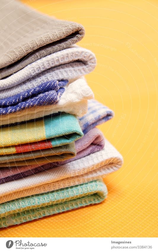 Stack of white clean towels on white background. Ironing clothes on ironing  board. Stack of clean towels on table. White towels. Space for text.  Hygiene, fabric, laundry,spa and textile concept. Stock Photo