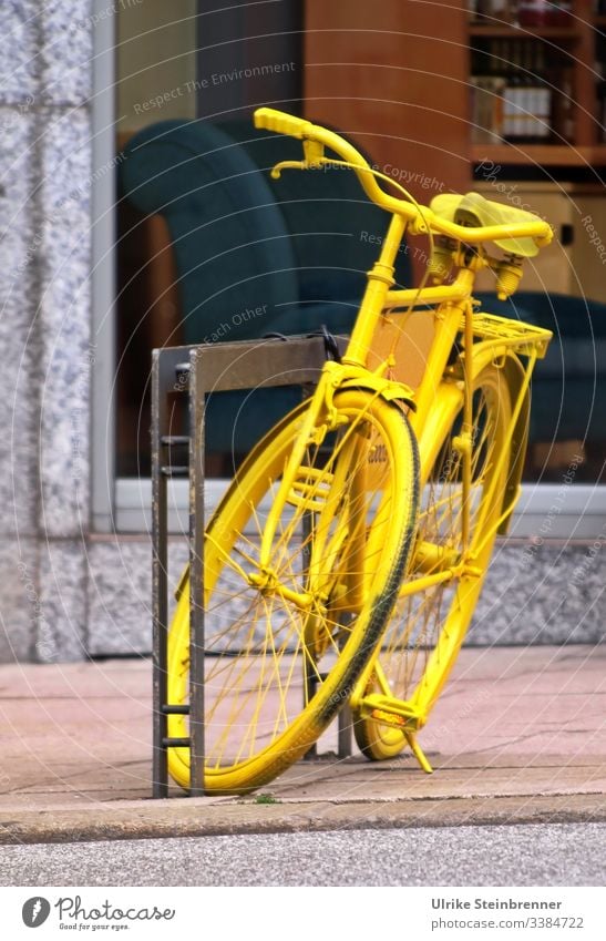 Yellow bicycle as decoration Bicycle turned off Decoration Attraction Eye-catcher Cycling Metal Means of transport Old Parking Town Bicycle rack Shop window