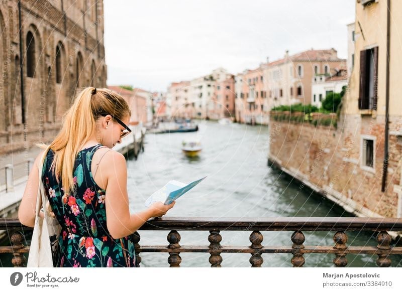 Young female traveler sightseeing in Venice , Italy adult architecture blogger boat bridge canal casual caucasian city cityscape cute europe european famous