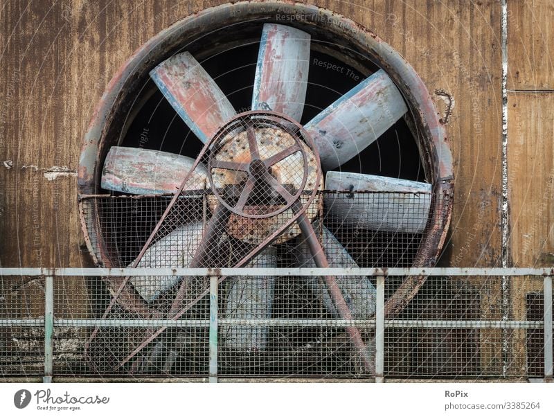 Industrial cooling fan on a deserted facility. compressor wheel old concrete blower supercharger production industry iron steel steelworks lost place metal