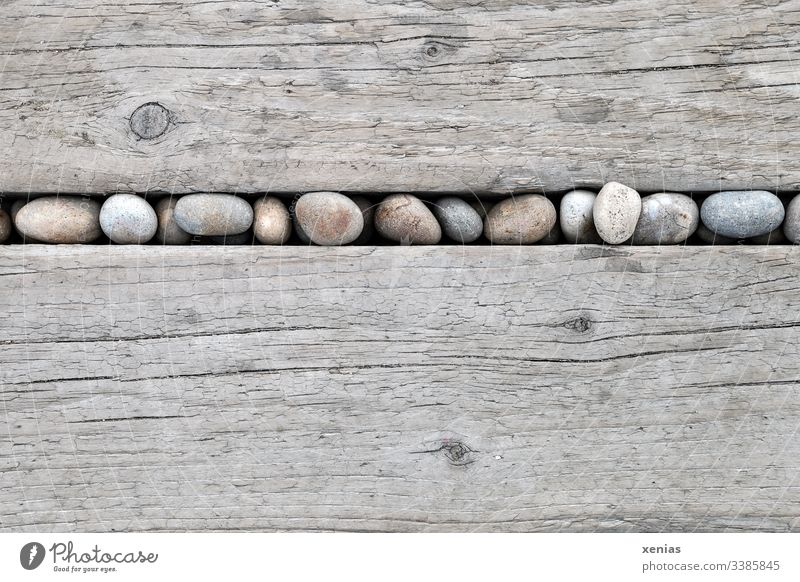 round stones in a row between light wooden boards Wood Row Bright Rustic Structures and shapes Line Pebble Stone wooden background Hard