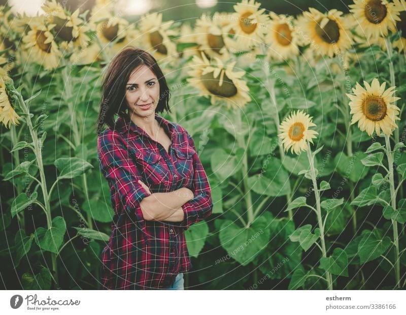Young Woman in Sunflower Field enjoy environment beautiful farm field freedom fun girl hair happy woman healthy landscape laugh life lifestyle meadow natural
