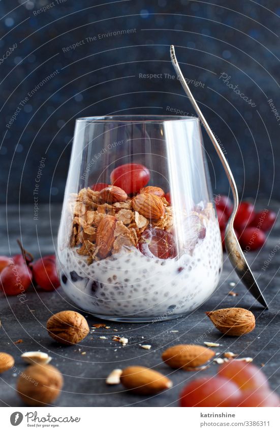 Chia pudding parfait with red grapes and almonds jar chia nuts seed chia seeds dairy dessert diet fruit glass breakfast greek yogurt healthy eating homemade