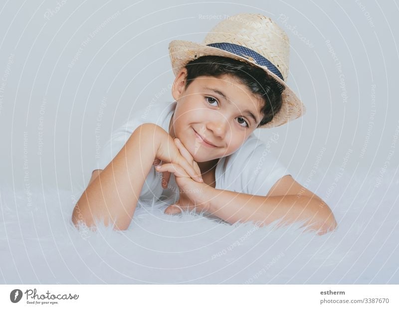 happy child smiling at camera childhood smile dreaming expression fun happiness hat portrait illusion innocence joy laugh love positivity reflection spring