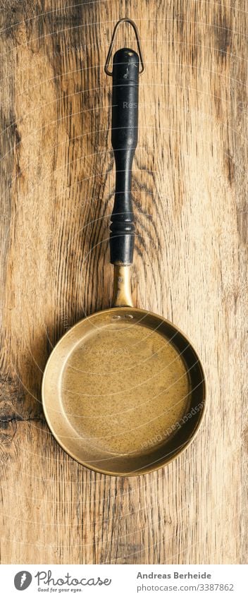 Old used pan on rustic wood background brass closeup cooking domestic empty equipment food handle healthy household ingredient kitchen kitchenware mesh metal