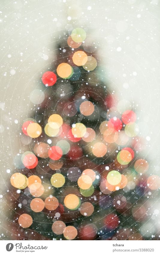 Bokeh christmas tree background with snowfall decorate festive vibrant illumination vivid magic beauty celebrate shapes ornament smooth glittering