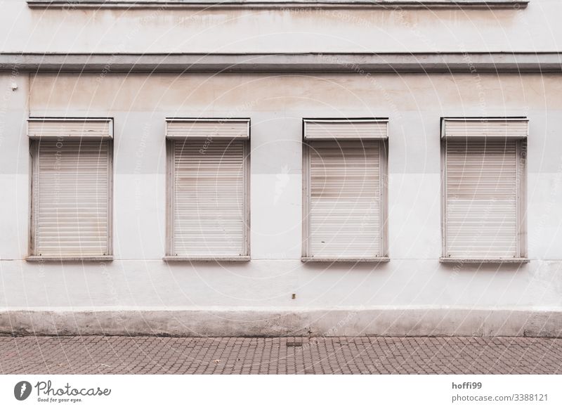 desolate exterior facade with closed blinds Gray Gloomy dreariness bleak jalousin Venetian blinds Roller shutter gray wall Unadorned Lonely depression