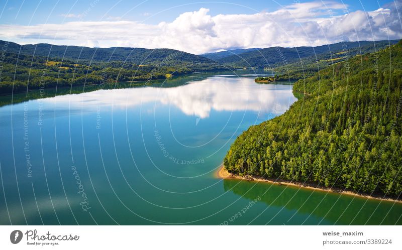 Reflection of sky, clouds, forest and mountains in water. Summer landscape with lake and mountain woodland summer aerial Slovakia reflection panorama alpine