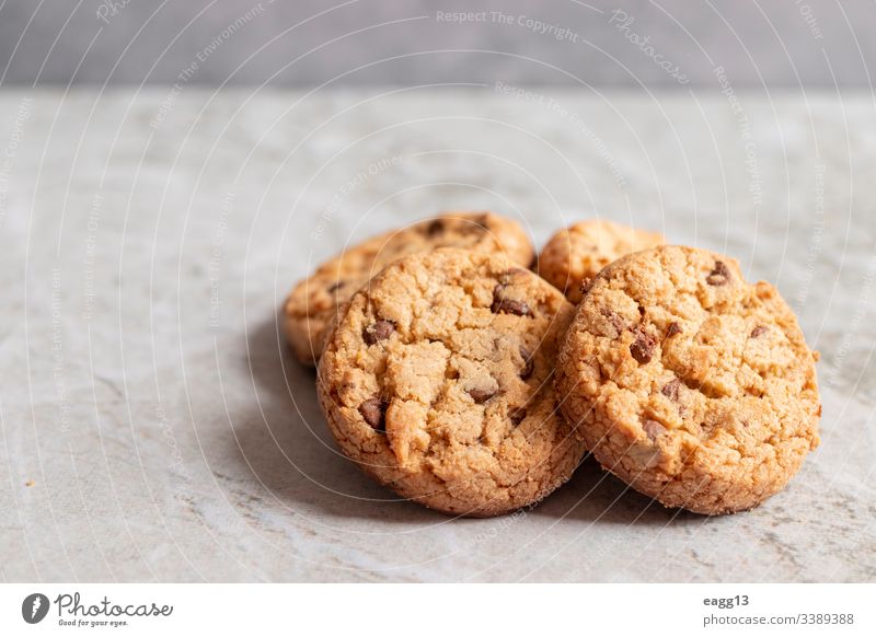 Freshly baked cookies placed on marbled texture appetizing bakery baking biscuits brown cakes calories chips chocolate close-up comfort crumbs decorations