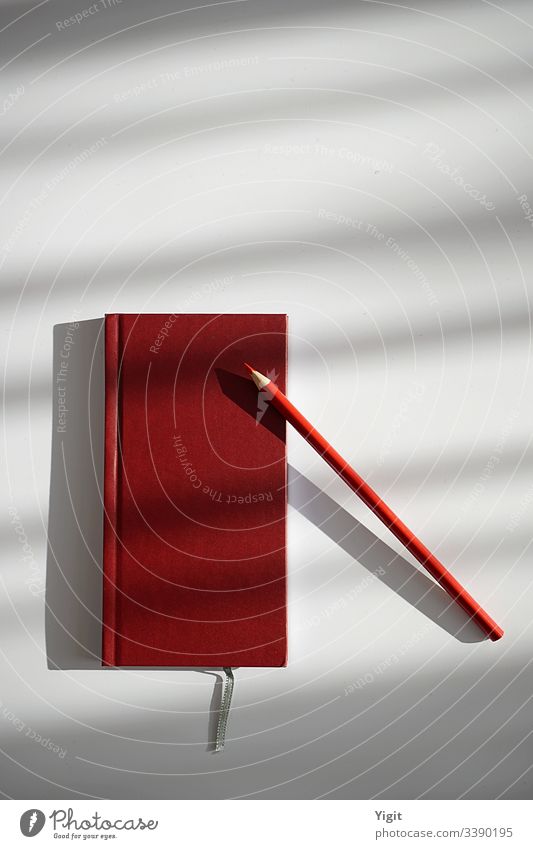 Still Life with Red Notebook and Pencil Communication Desk Table Workplace Office Stationery Conceptual design Organized Creativity Colour Studio shot