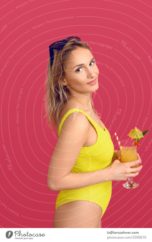 Attractive trendy blond woman with exotic cocktail Trendy attractive beverage body camera conceptual drink glass happy head her isolated leisure lifestyle