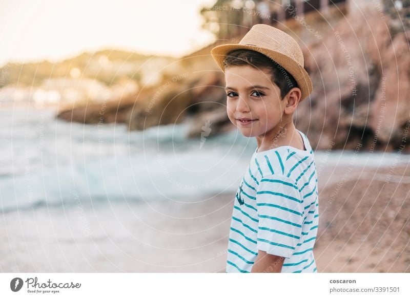 Little kid with hat looking the sea on the beach back background beautiful blue child childhood children coast contemplation cute enjoying fashion fashionable