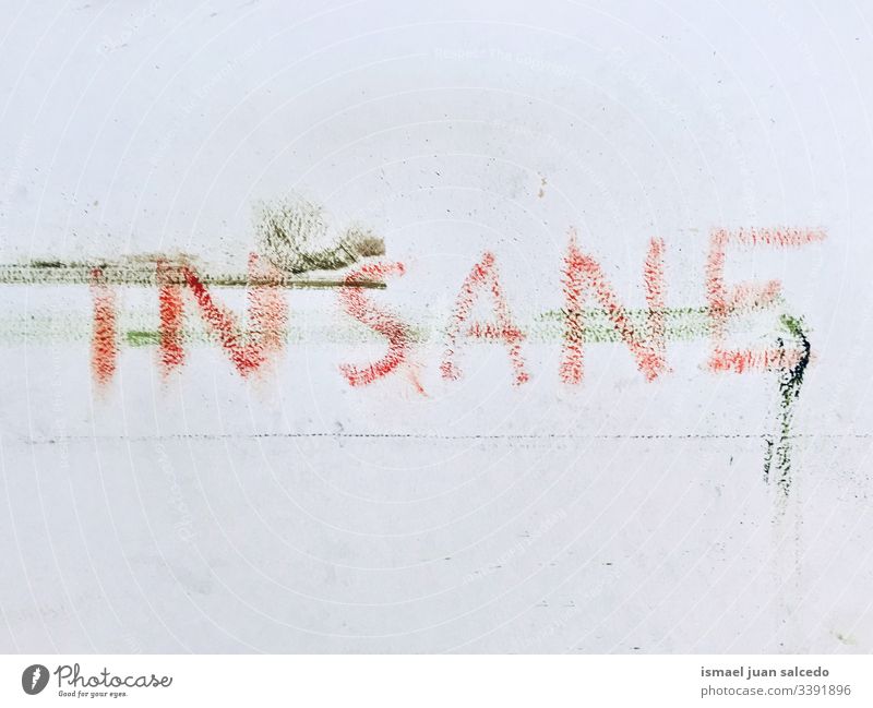 insane word painted on the dirty white wall letters words Characters Wall (building) Wall (barrier) Dirty Letters (alphabet) Word Graffiti Typography Facade Old