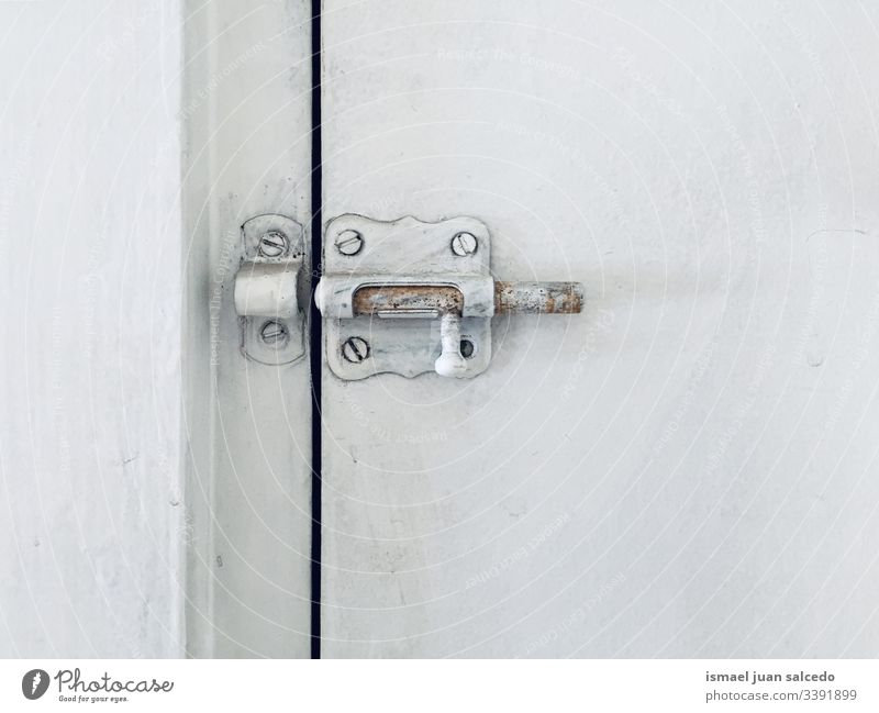 lock on the white door old dirt dirty wooden abandoned close open Minimalistic background surface screws