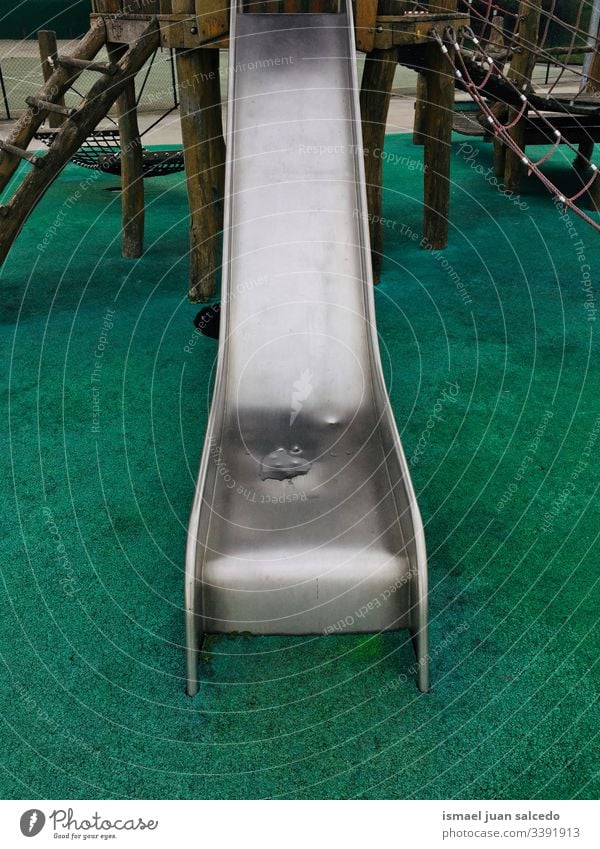 metallic slide on the playgroundo on the street in Bilbao city Spain Slide swing playing playtime playful fun park public park outdoors childhood old colors