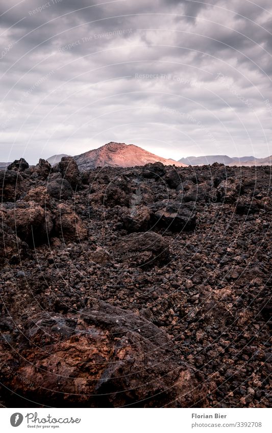Volcanic rock and volcanic mountains Landscape Nature Lunar landscape Volcano Stone stone Clouds in the sky Sunset Hard Mountain Deserted Environment Earth