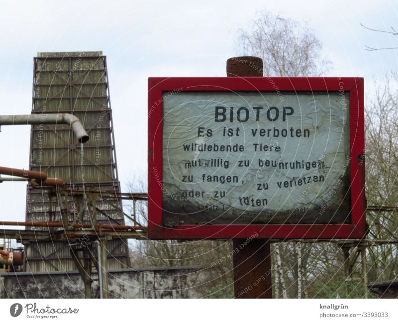 Biotope sign in front of old industrial plant Habitat Signage Industrial plant Warning sign Signs and labeling Exterior shot Characters Deserted Colour photo