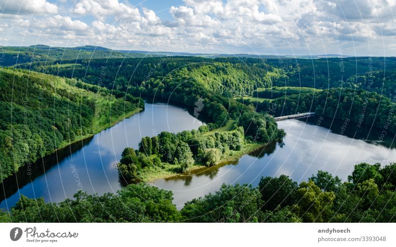 headland with a river and a dam above aerial Background beautiful beauty blue clouds course day edge flow flowing foresight forest forrest germany grass green