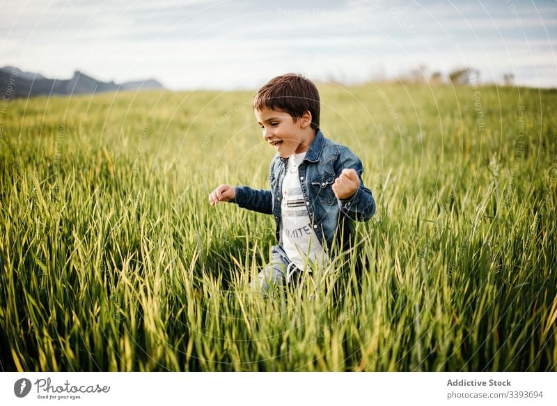 Happy boy in green field a Royalty Free Stock Photo from Photocase