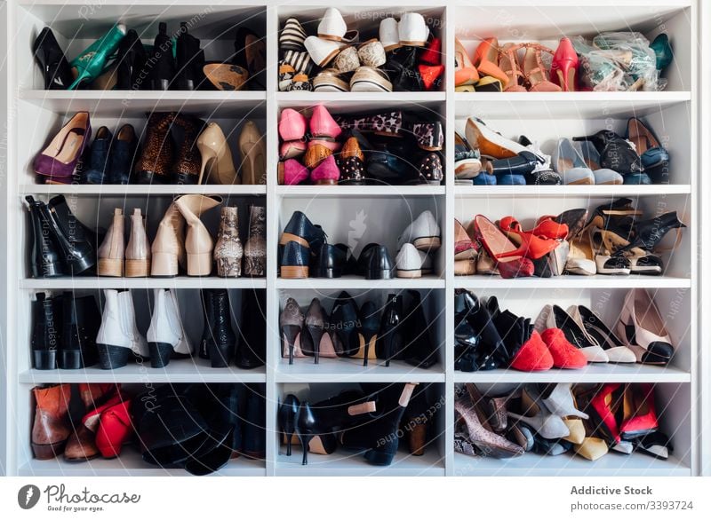 Assortment of female shoes in wardrobe footwear closet apartment shelf high heels colorful expensive rack storage various style fashion assorted design