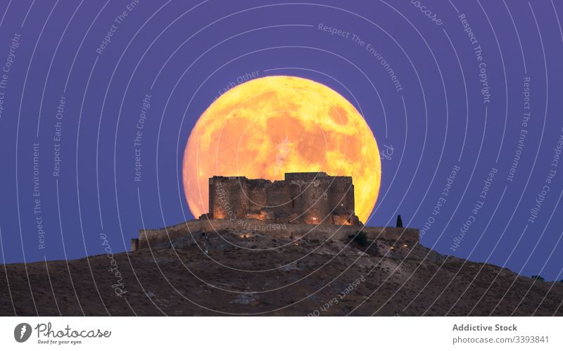 Breathtaking landscape of ruined castle and Moon at night moon scenery abandoned aged fortress illuminated eclipse lunar environment full ancient tourism old