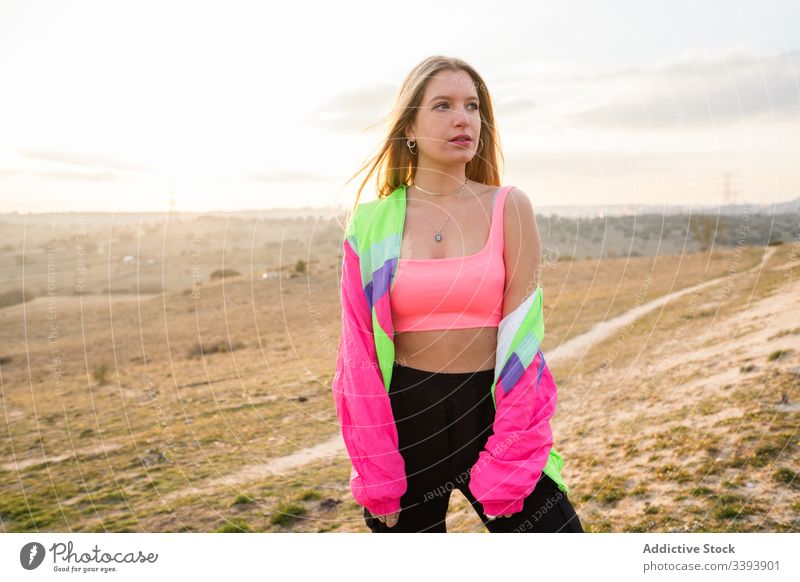 Female hipster in colorful sportswear in countryside woman nature modern blond casual summer individuality style fit cool trendy vivid young athlete female
