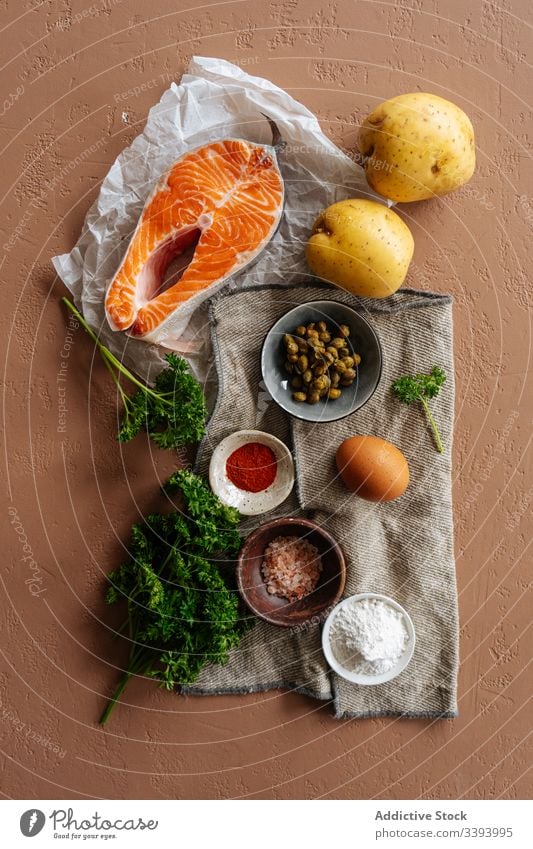 Ingredients for recipe with fish and vegetables ingredient food salmon cooking healthy potato spices steak parsley kitchen meal dinner lunch seafood preparation