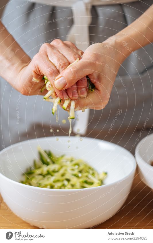 Woman squeezing grating zucchini in kitchen cooking food squeeze woman recipe vegetable ingredient hands healthy meal female housewife dinner lunch homemade