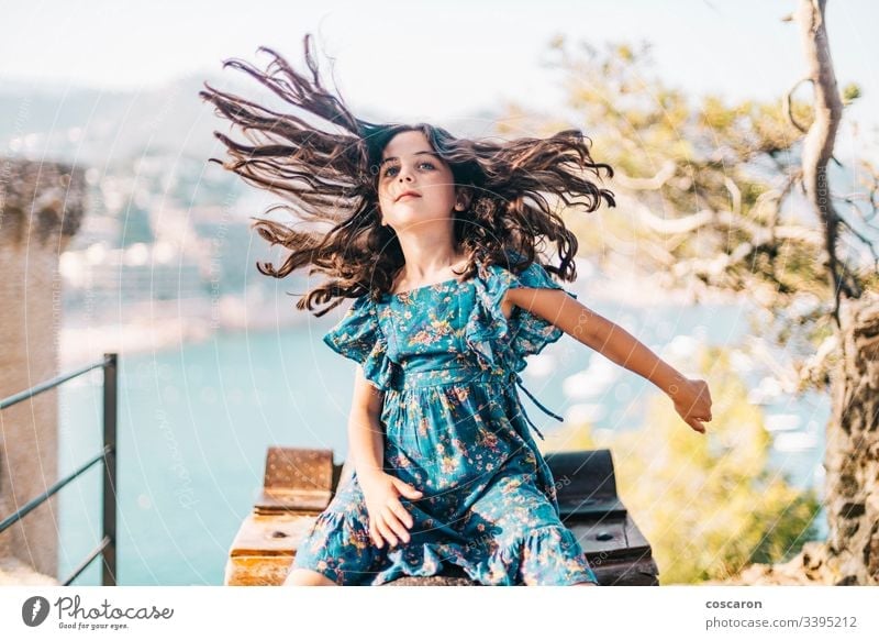 Funny little girl moving her long hair activity adorable arms wide open beautiful beauty caucasian chic child childhood clothes coast cute energy face