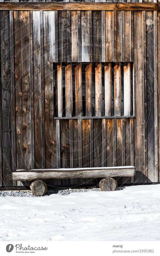 Plain wooden bench in front of a wooden wall, with a window barricaded with square timbers. Wooden wall Brown Wood grain Wall (building) Window Rectangle