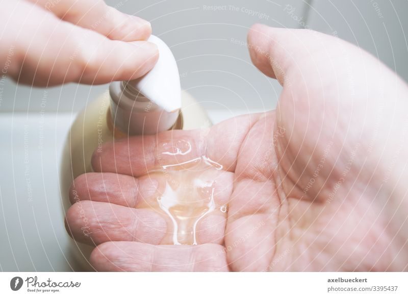 using liquid soap dispenser before washing hands hygiene clean use apply bathroom sink health care sanitary healthcare press closeup close-up unrecognizable