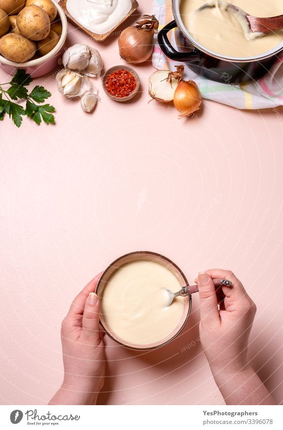 Woman hands eating cream soup. Potato and garlic soup above view bowls creamy cuisine delicious dish eating soup food gastronomy gourmet healthy food overhead