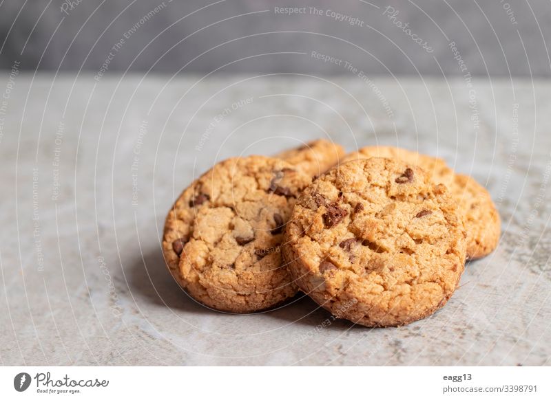 Freshly baked cookies placed on marbled texture appetizing bakery baking biscuits brown cakes calories chips chocolate close-up comfort crumbs decorations