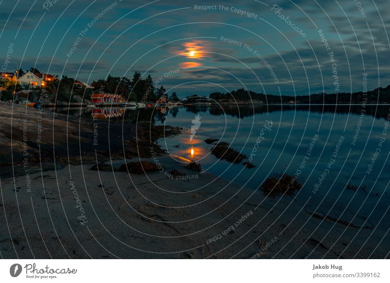 Moonlight reflected in the water in a lake in Norway Coast reflection Reflection in the water sunset smooth smooth water surface Ocean Water Landscape Lake