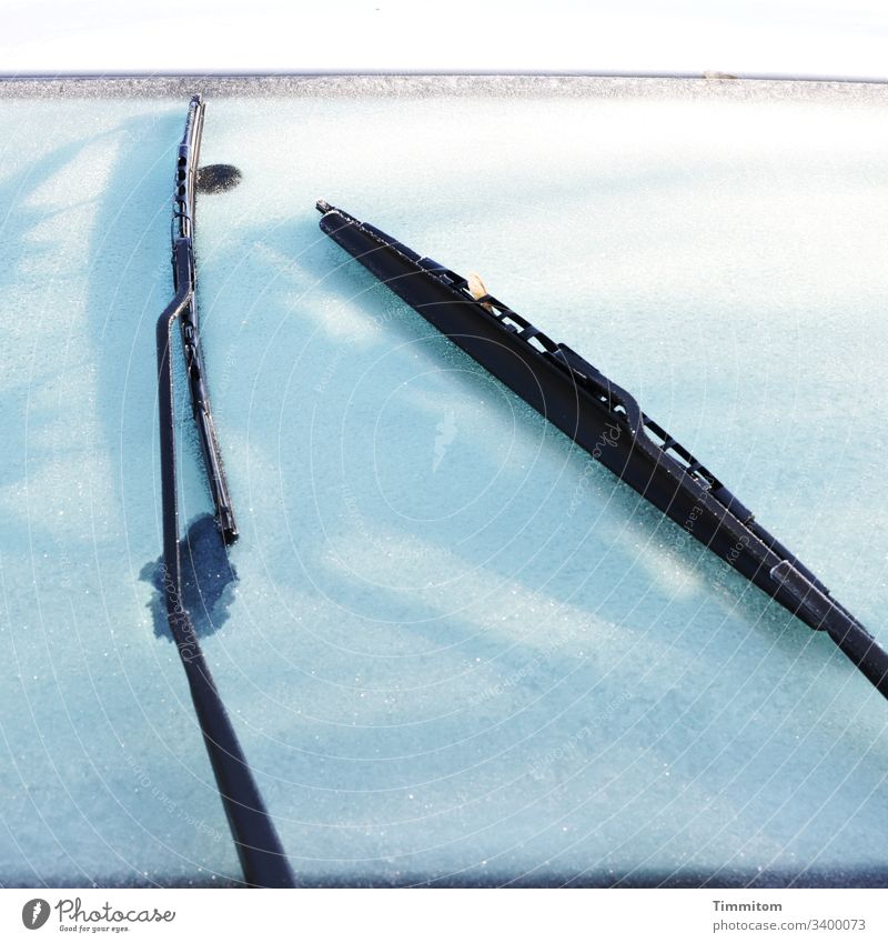Frost on car window Winter ice crystals FRontwheel Windscreen wiper Cold Frozen Exterior shot Deserted White Black