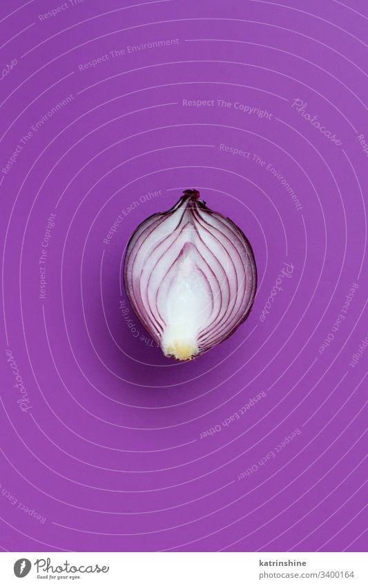 Purple onion on a purple background top view above red sliced half food healthy raw organic vegetable ingredient vegetarian ripe vitamin natural harvest fresh