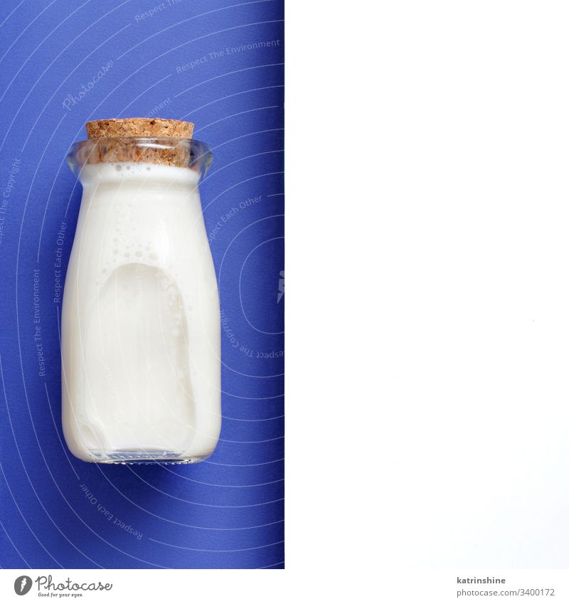 Milk on a white and blue background milk beverage jar minimal top view above classic blue bottle breakfast diet drink negative space copy space food fresh glass
