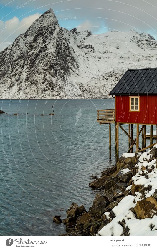 Hamnoy in the Lofoten Islands Blue vacation Water Idyll Reinefjorden Fjord Coast cloudy Travel photography voyage Vacation in Norway Snowscape stilt house