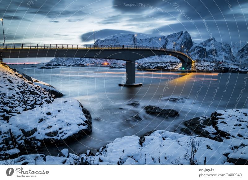 Bridge at Hamnoy in the Lofoten lanterns Lighting Long time exposed North Relaxation Winter vacation Ocean Snow Hamnöy Central perspective Environment