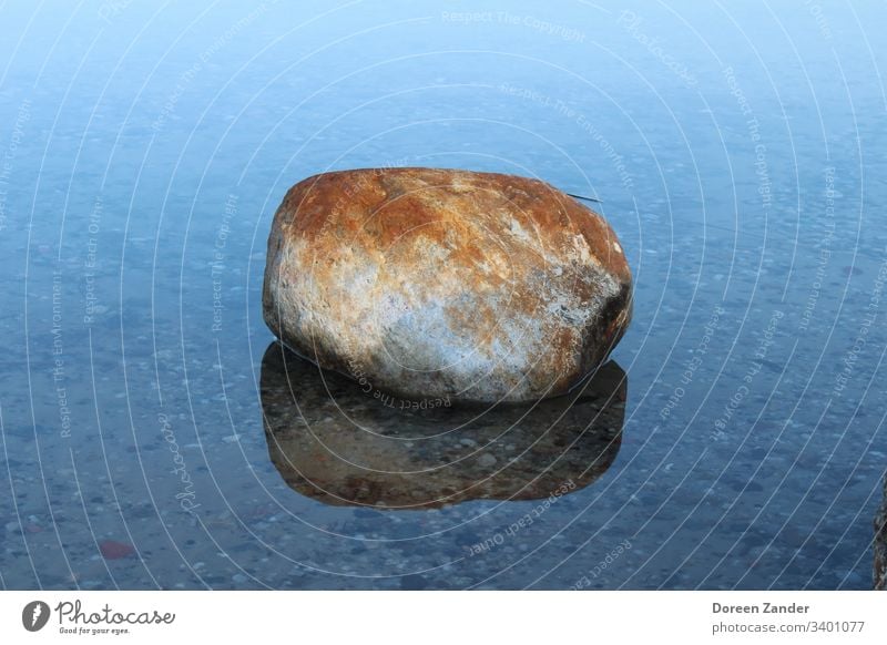 The lonely stone in the water Stone Water Lake Sky Nature Blue Clouds Deserted Background picture Rock Ocean Exterior shot Landscape Colour photo Coast